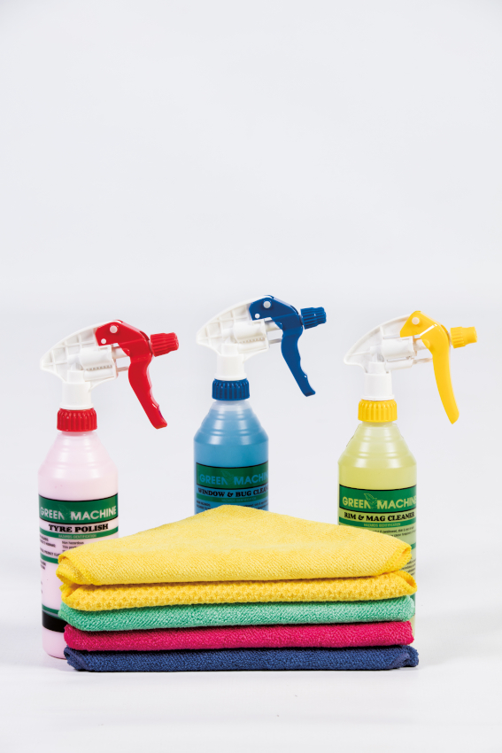 Person cleaning car with spray